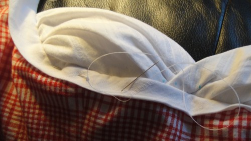 Hand stitching the cups in place.